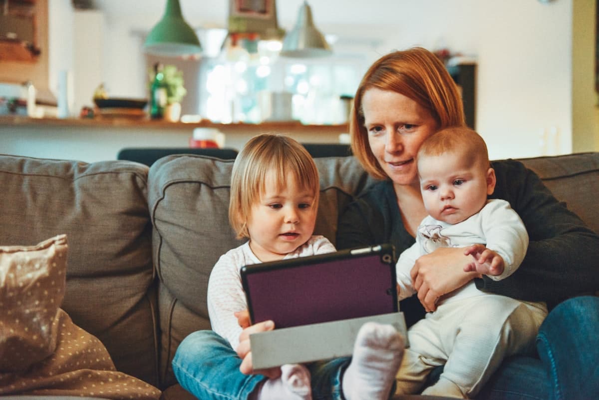 Parent reading with two young children at home, representing Texas family law matters
