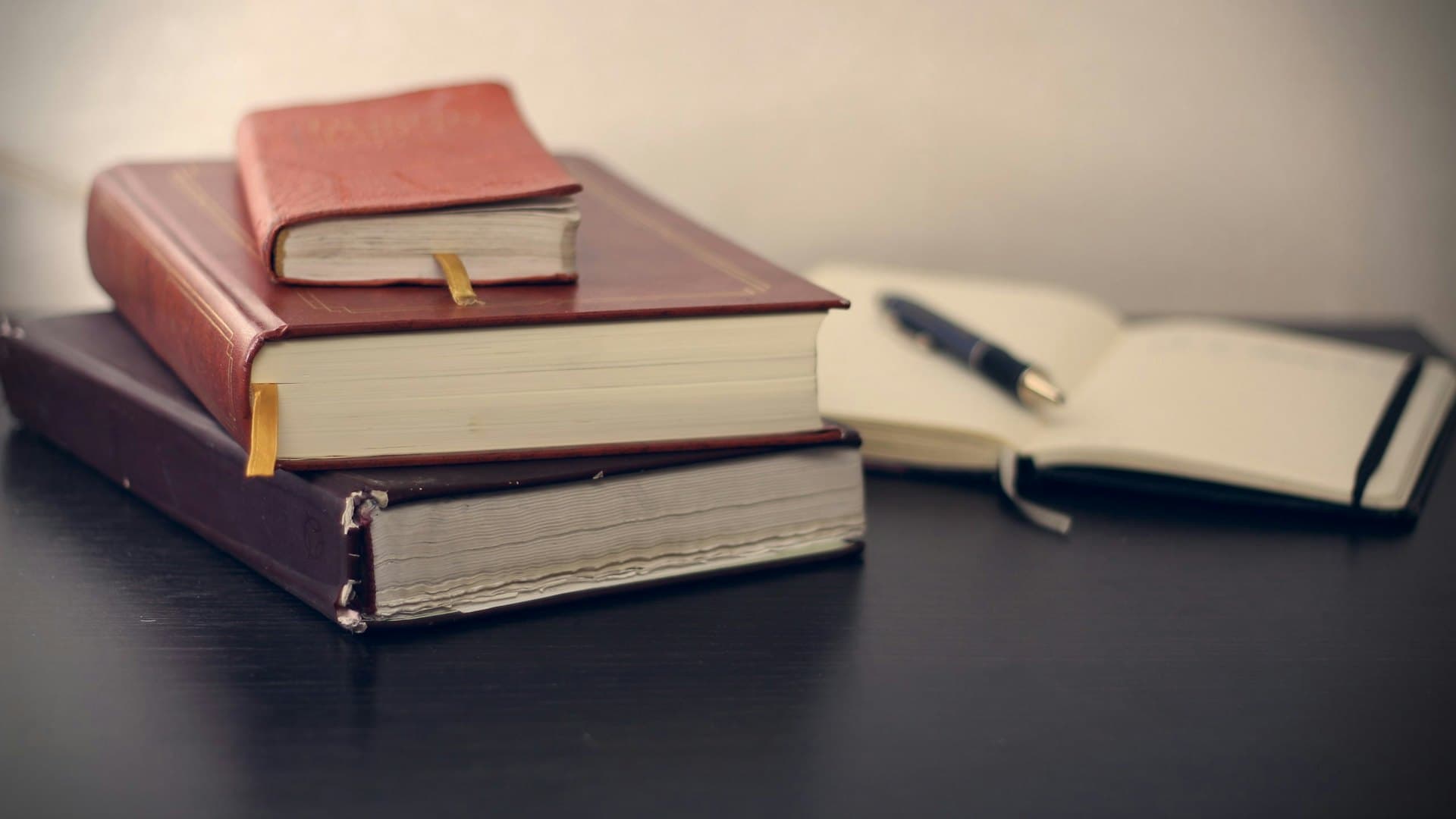 Stack of law books and a pen on a desk