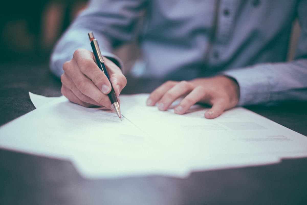Signing legal documents, illustrating a Texas divorce filing